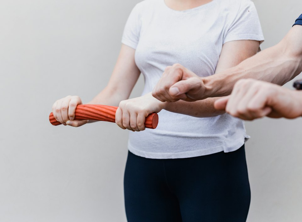 Physiotherapist guiding a resistance exercise